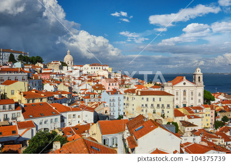 View of Lisbon famous postcard iconic view from Miradouro de Santa Luzia tourist viewpoint over Alfama old city district. Lisbon, Portugal. 104375739
