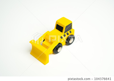 Yellow toy bulldozer, top view copy space. Demolition services, land leveling and other land works. Take down Illegal buildings. Industry machinery for rent Yellow toy bulldozer, top view copy space. Demolition services, land leveling and other land works. Take down Illegal buildings. Industry machinery for rent 104376641