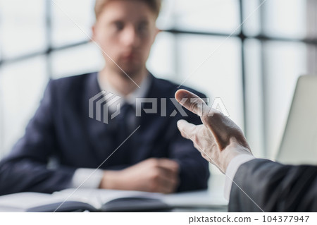 Close up of diverse businesspeople gather at office desk discuss company financial paperwork at meeting together Close up of diverse businesspeople gather at office desk discuss company financial paperwork at meeting together 104377947