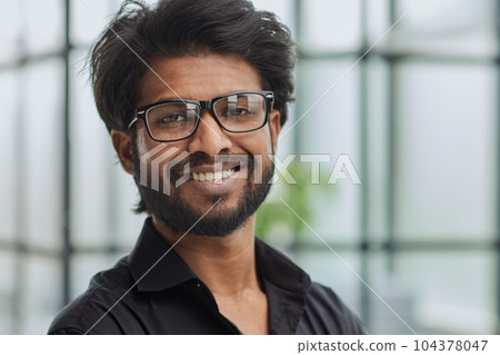 Funny vintage style guy adjusting his glasses and smiling Funny vintage style guy adjusting his glasses and smiling 104378047
