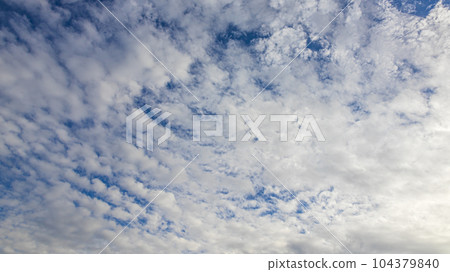 White clouds flowing in the blue sky at noon 104379840