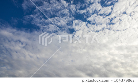 White clouds flowing in the blue sky at noon 104379862