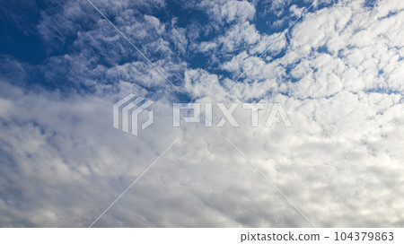 White clouds flowing in the blue sky at noon 104379863