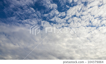 White clouds flowing in the blue sky at noon 104379864