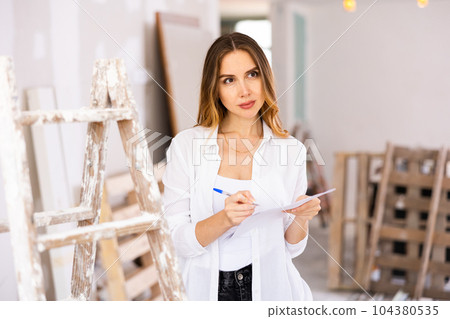 Young woman takes important notes on paper 104380535