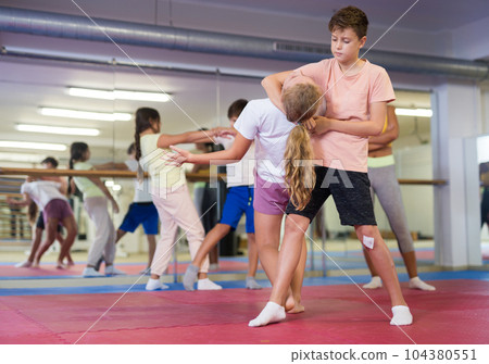 Teenager kids exercising self-defense movements 104380551