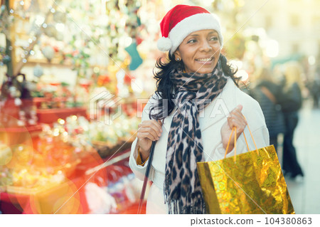 Latin woman at christmas fair 104380863