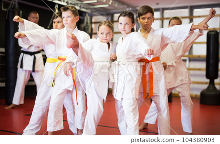 Boys and girls in kimono with trainer 104380903