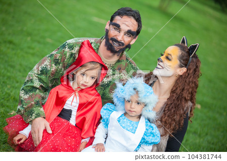 Real family having fun while using costumes of the Little red riding hood tale in Halloween. 104381744