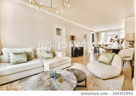 a living room with two couches and a coffee table in the photo is taken from the front end of the room 104381993