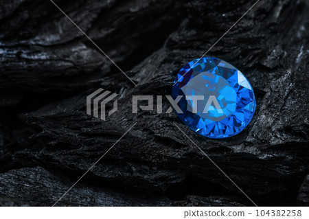 blue sapphir on black coal background blue sapphir on black coal background 104382258