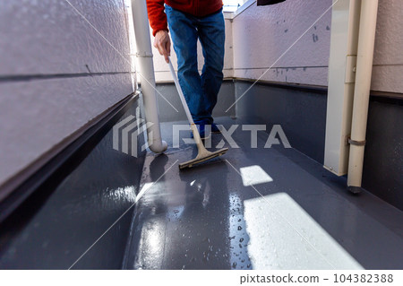A man cleaning the balcony Balcony A man cleaning the balcony Balcony 104382388