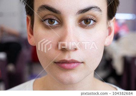 Portrait of a caucasian woman after eyelash lamination procedure.  104382684