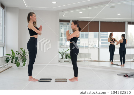 Two women meditate before practicing nailing on sadhu boards.  104382850