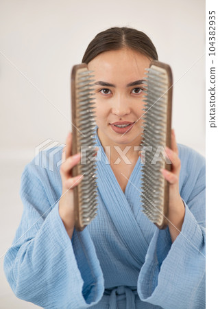 Asian woman holding sadhu boards on face background.  104382935