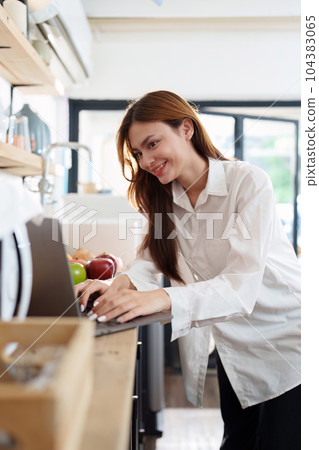 Portrait of a young cheerful asian woman at kitchen room with healthy raw food. Vegetarianism, wellbeing and healthy lifestyle concept Portrait of a young cheerful asian woman at kitchen room with healthy raw food. Vegetarianism, wellbeing and healthy lifestyle concept 104383065