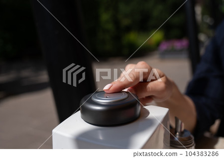 Woman pressing button to call waiter in cafe. Woman pressing button to call waiter in cafe. 104383286