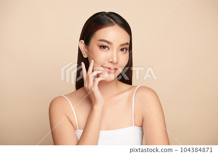 Beautiful young asian woman with clean fresh skin on beige background, Face care, Facial treatment, Cosmetology, beauty and spa, Asian women portrait. Beautiful young asian woman with clean fresh skin on beige background, Face care, Facial treatment, Cosmetology, beauty and spa, Asian women portrait. 104384871