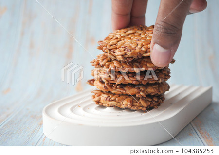close up of sesame cookies on wooden table close up of sesame cookies on wooden table 104385253