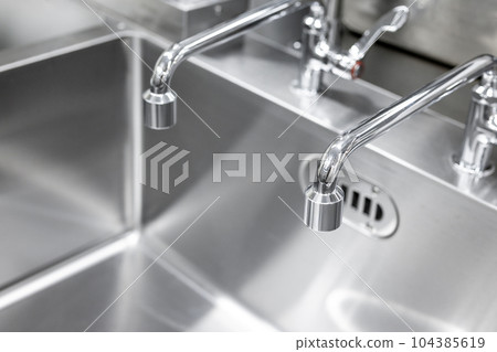 Commercial sink and two faucets in the kitchen 104385619