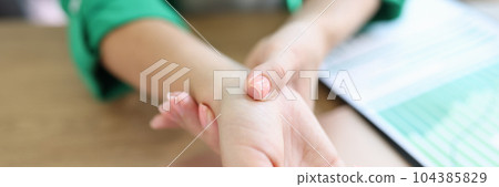 Woman holding sore wrist from using computer 104385829