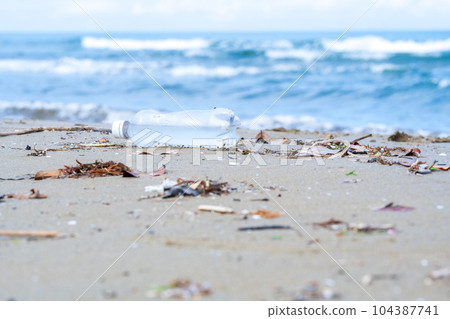 Plastic bottles washed up on the beach | Marine garbage image | Coastal cleaning image 104387741