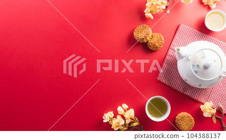 Chinese Mid-Autumn Festival concept made from mooncakes, tea and plum blossom on red background. Chinese Mid-Autumn Festival concept made from mooncakes, tea and plum blossom on red background. 104388137