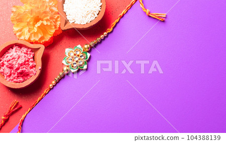 Raksha Bandhan, Indian festival with beautiful Rakhi and Rice Grains.  A traditional Indian wrist band which is a symbol of love between Sisters and Brothers. 104388139
