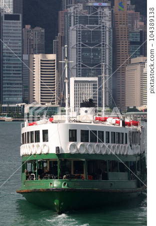 Star ferry sailing through Victoria Bay in Hong Kong 104389138