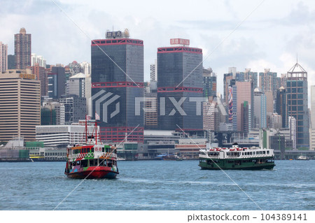 The Star Ferry in Hong Kong's Victoria Harbor. The left is a ferry painted for sightseeing 104389141