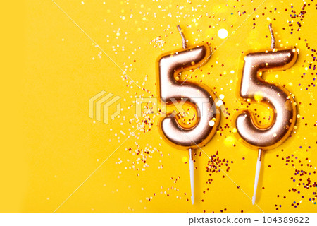 55 years celebration. Greeting banner. Gold candles in the form of number forty on yellow background with confetti. 55 years celebration. Greeting banner. Gold candles in the form of number forty on yellow background with confetti. 104389622