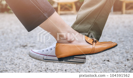 Close-up of two woman foot tap for greeting during coronavirus epidemic. The foot tap or foot shake was suggested as an alternative way for reduce your risk of spreading or contracting the virus. Close-up of two woman foot tap for greeting during coronavirus epidemic. The foot tap or foot shake was suggested as an alternative way for reduce your risk of spreading or contracting the virus. 104391562
