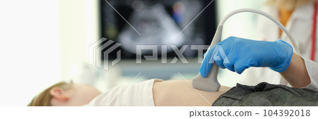 Doctor gastroenterologist making ultrasound examination of liver and pancreas to child in clinic closeup Doctor gastroenterologist making ultrasound examination of liver and pancreas to child in clinic closeup 104392018
