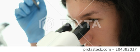 Laboratory diagnostics doctor looking into microscope and making blood test in clinic Laboratory diagnostics doctor looking into microscope and making blood test in clinic 104392037