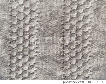 Gray knitted texture woolen fabric Textile knit pattern wallpaper background surface design. Handmade shop cozy backdrop 104392111
