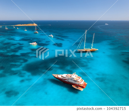 Aerial view of luxury yachts and boats on blue sea at sunset 104392715