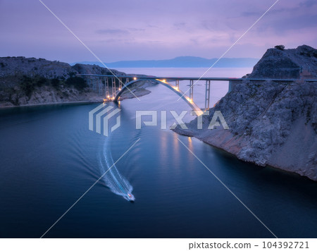 Bridge over the sea at sunset. Aerial view of modern Krk bridge 104392721