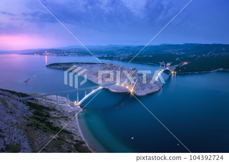 Bridge over the sea at sunset. Aerial view of modern Krk bridge 104392724