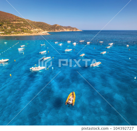 Aerial view of motorboats on blue sea at sunset in summer 104392727