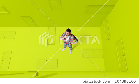 Conceptual design. Man with doubtful, thoughtful face standing around many closed doors over green background. Choice Conceptual design. Man with doubtful, thoughtful face standing around many closed doors over green background. Choice 104393100