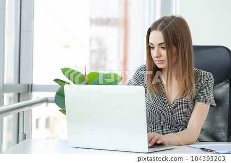 Young woman at workplace in modern office 104393203