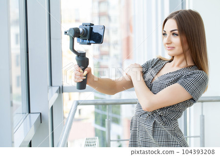 Smiling businesswoman looking at camera make conference business call 104393208