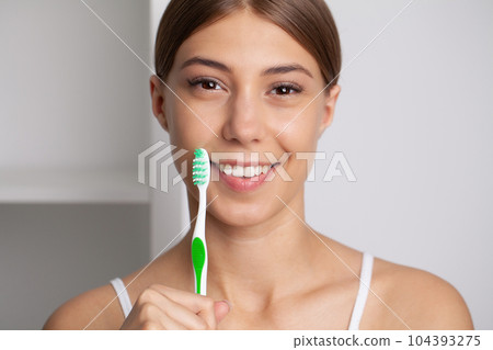 Happy Lady Brushing Teeth With Toothbrush Standing In Bathroom Happy Lady Brushing Teeth With Toothbrush Standing In Bathroom 104393275