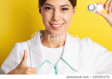 An ophthalmologist doctor shows contact lenses in his hand 104393279