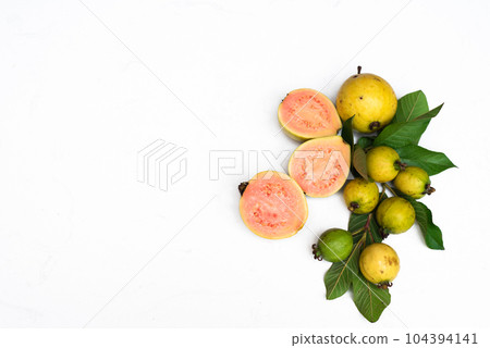 Ripe guava fruit with leaves on white background with copy space 104394141