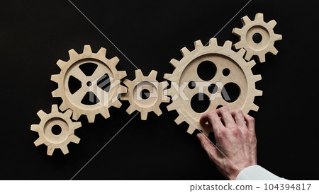 Wooden mechanisms on a black background. Black chalk board. Wooden mechanisms on a black background. Black chalk board. 104394817