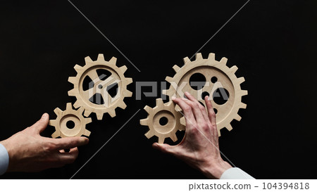Wooden mechanisms on a black background. Black chalk board. Wooden mechanisms on a black background. Black chalk board. 104394818