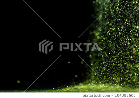 Explosion metallic green glitter sparkle. Green Glitter powder spark blink celebrate, blur foil explode in air, fly throw green glitters particle. Black background isolated, selective focus Blur bokeh Explosion metallic green glitter sparkle. Green Glitter powder spark blink celebrate, blur foil explode in air, fly throw green glitters particle. Black background isolated, selective focus Blur bokeh 104395605