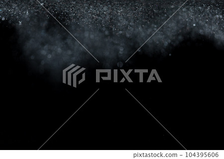 Explosion metallic black glitter sparkle. Dark Glitter powder spark blink celebrate, blur foil explode in air, fly throw black glitters particle. Black background isolated, selective focus Blur bokeh 104395606