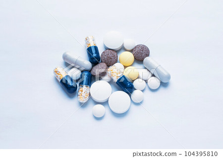 Tablets and pills on the white table, consuming a lot of pills concept 104395810